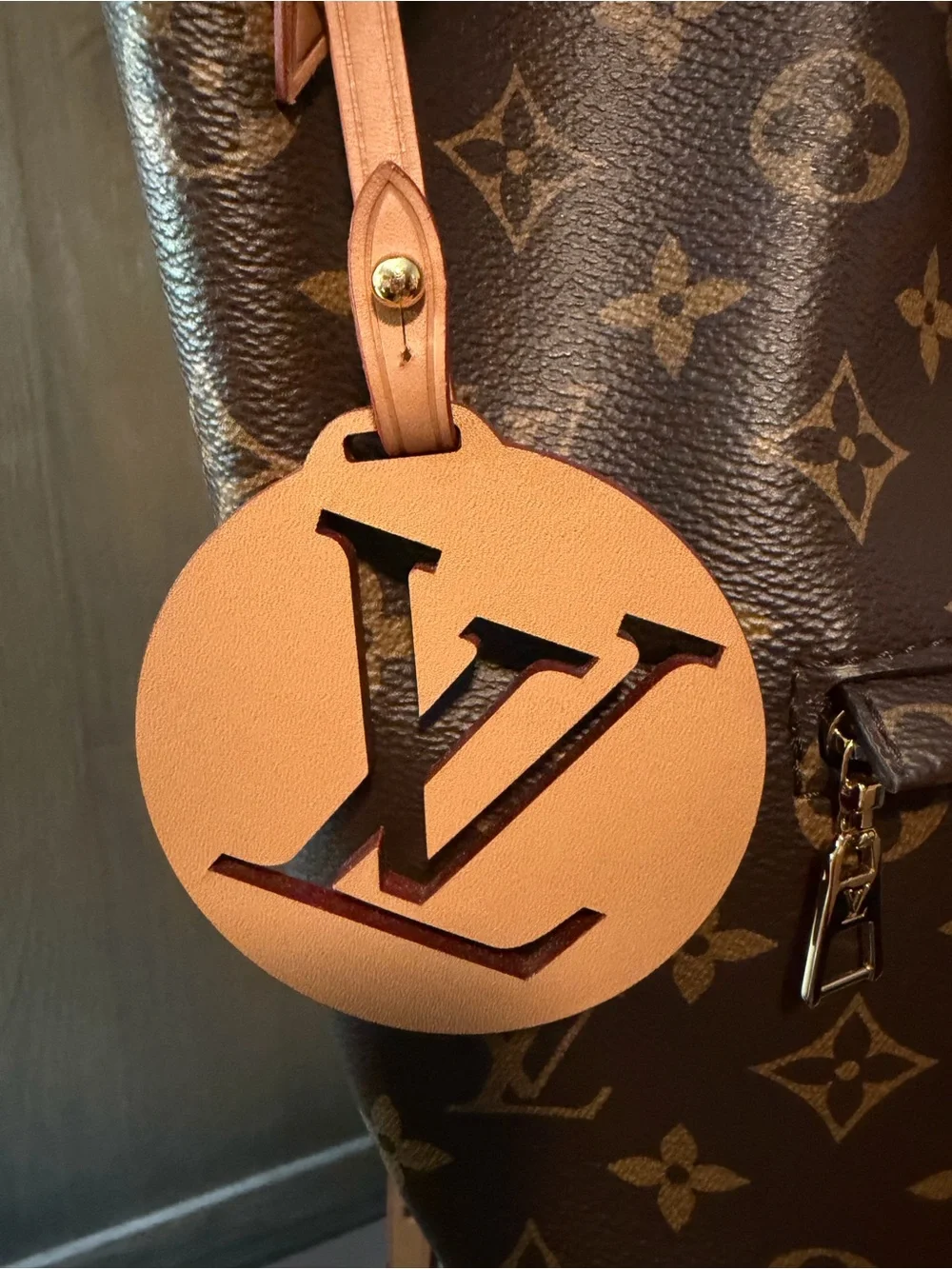 Louis Vuitton Monogram Canvas Backpack with Tan Leather Trim and Pink Charm